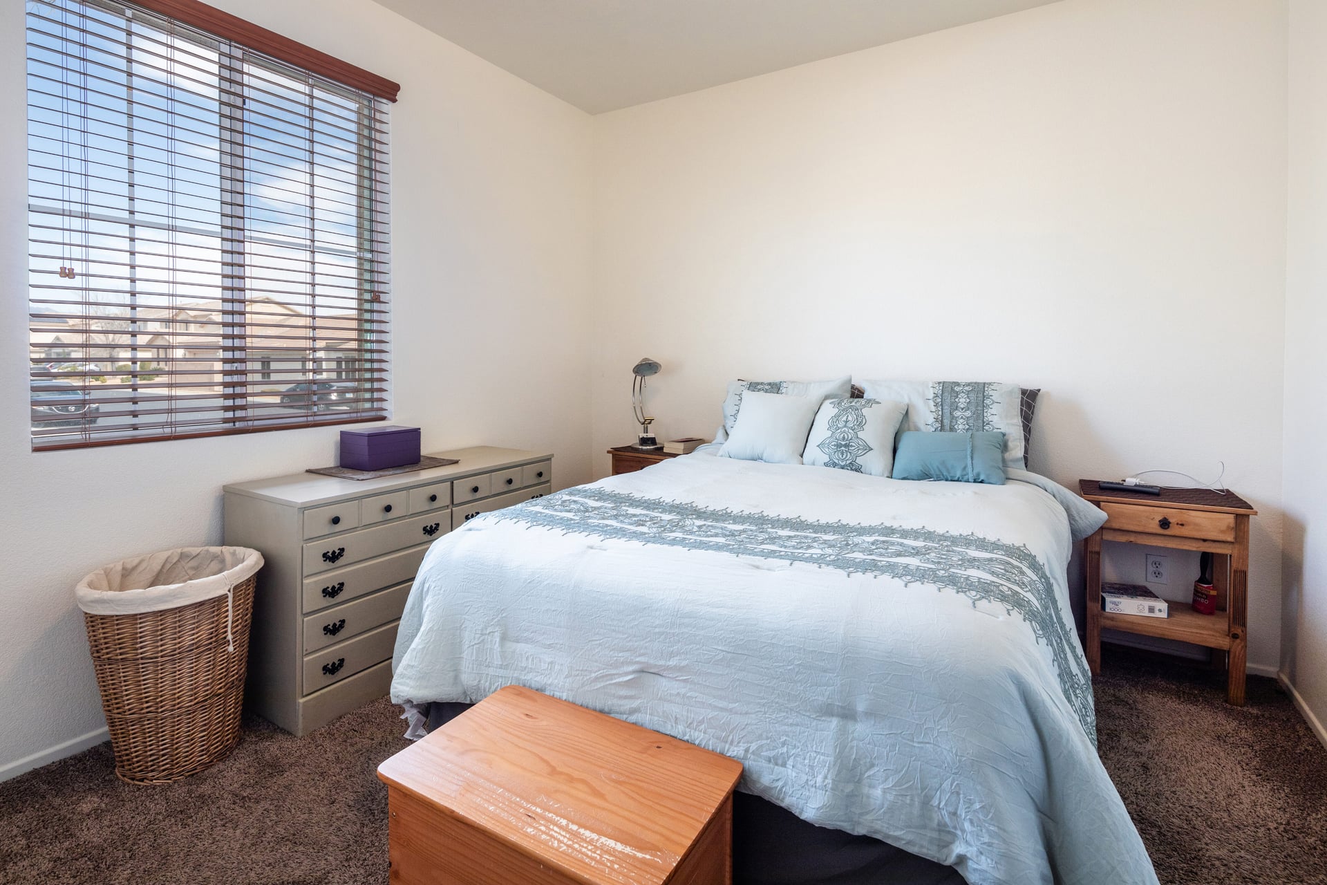 Large master bedroom with king bed and windows